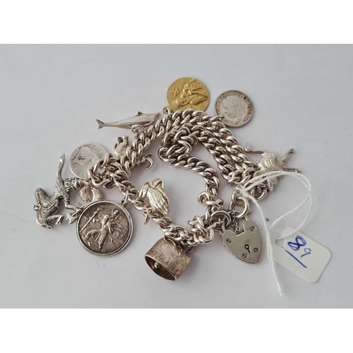 89 - A silver charm bracelet - 96 gms