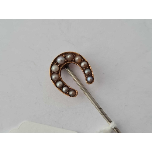 99 - A gold topped pearl stick pin