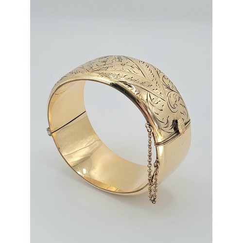 200 - 9ct gold metal core bangle , 38.7g