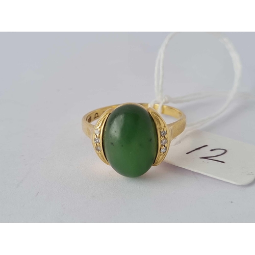 12 - A vintage green stone ring with three diamonds mounted on each side 14ct gold size T  5 gms