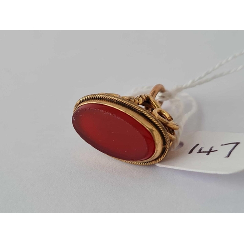 147 - Antique seal with scroll design set with a carnelian coloured stone.