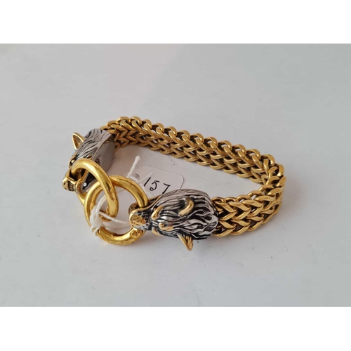 157 - A unusual designer gilt metal heavy mesh bracelet the end clasp being two snarling wolf heads