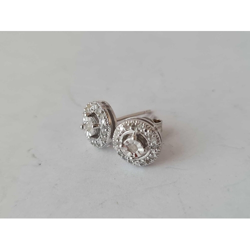 180 - A pair of silver and diamond cluster earrings