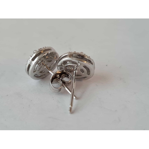 180 - A pair of silver and diamond cluster earrings