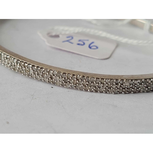 256 - A silver and diamond bangle one diamond missing