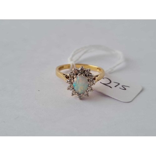 275 - An opal and diamond cluster ring in 18ct gold size L 3.3g inc