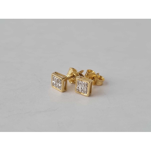 351 - A pair of 9ct ear studs each set with 4 small diamonds