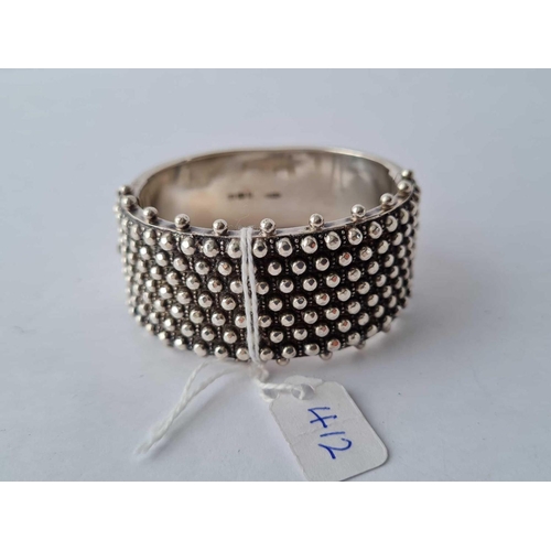 412 - A fancy wide silver bangle