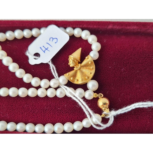 413 - A string of pearls with a 18ct gold clown drop and clasp