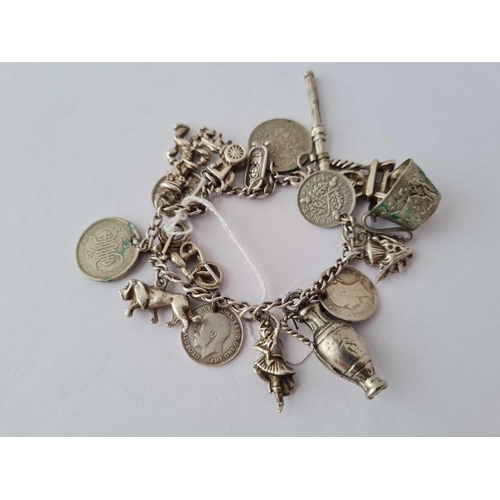 73 - A silver charm bracelet with charms 46.5g inc