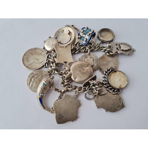 74 - A bag of silver items including charm bracelet, fobs etc 145g inc