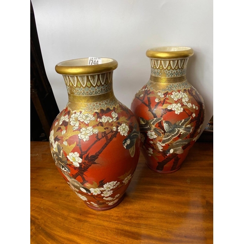 1744 - A good decorative pair of Satsuma vases with gilt necks and bodies painted with birds amongst foliag... 