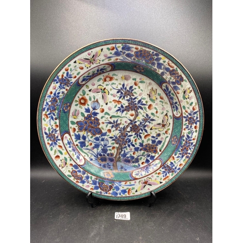 1749 - A Chinese charger enamelled with butterflies amongst flowering plant, 13” diameter