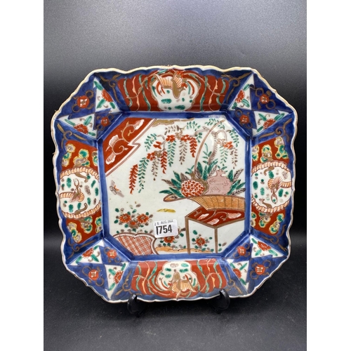 1754 - An octagonal Imari plate with basket of flowers, 11.5” wide