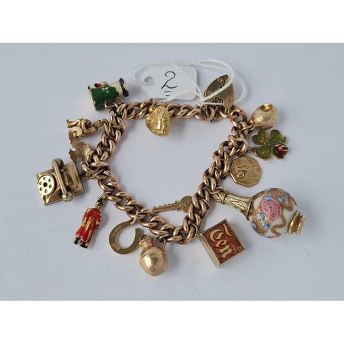 2 - A HEAVY VINTAGE 9CT GOLD CHARM BRACELET WITH 14 ASSORTED  CHARMS 45.2g