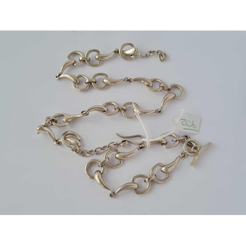 206 - A silver bracelet and chain of Equestrian interest being in the form of bridles and bits  89 gms