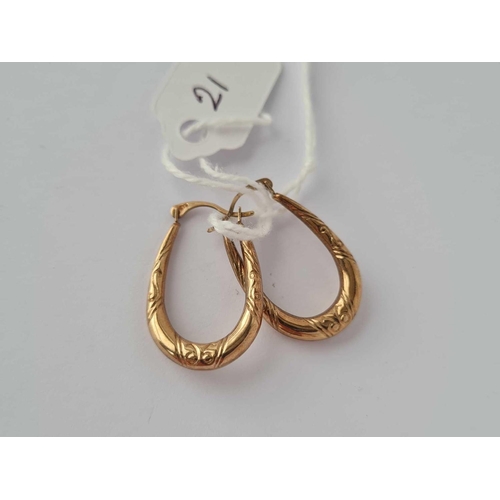 21 - A pair of hoop earrings 9ct