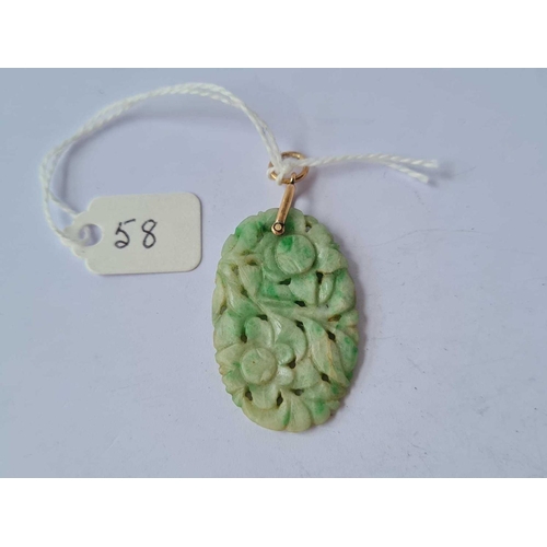 58 - A carved jade and gold pendant