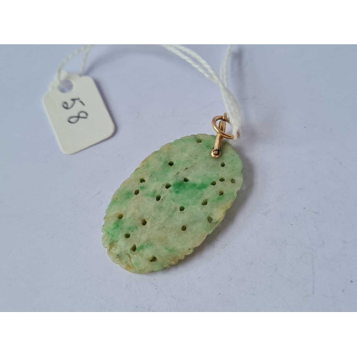 58 - A carved jade and gold pendant