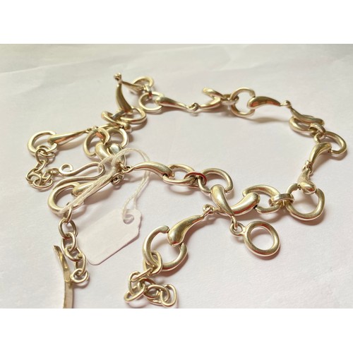 206 - A silver bracelet and chain of Equestrian interest being in the form of bridles and bits  89 gms