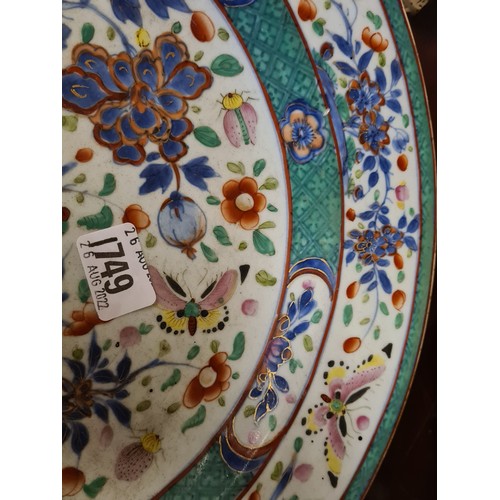 1749 - A Chinese charger enamelled with butterflies amongst flowering plant, 13” diameter