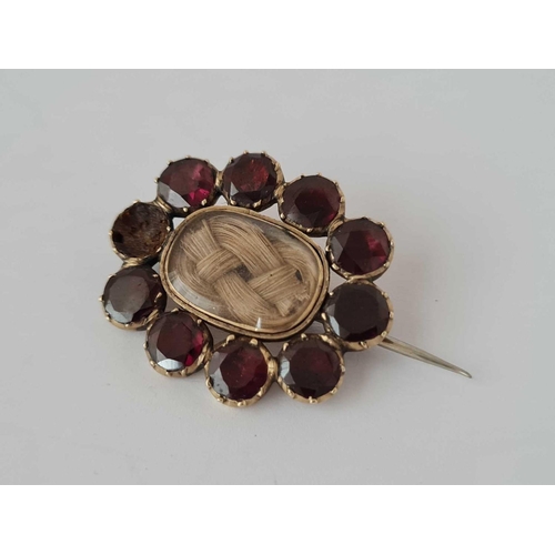 121 - Two Georgian mourning brooches one with garnets