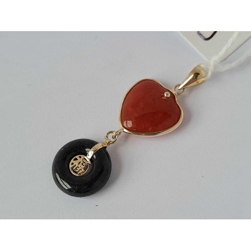 179 - A pretty carnelian and black jade heart and disc high carat good luck and love pendant