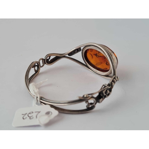 232 - A silver and amber bangle