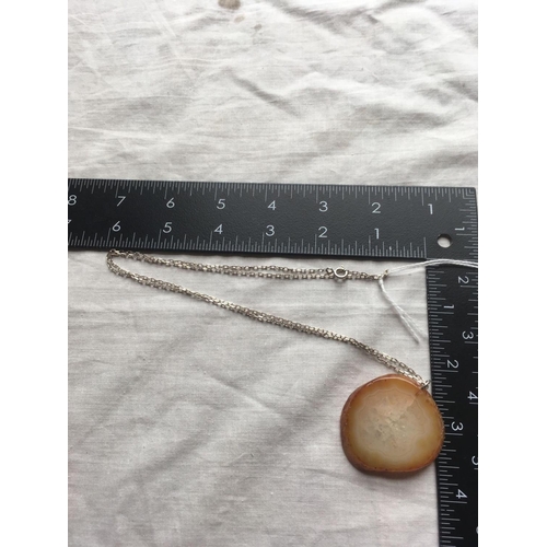 110 - A large agate pendant on silver chain