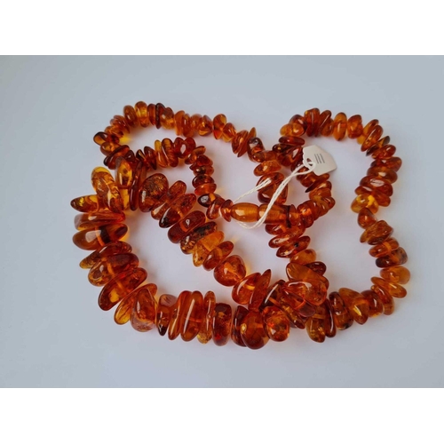 111 - A string of amber beads 24 inch     75 gms