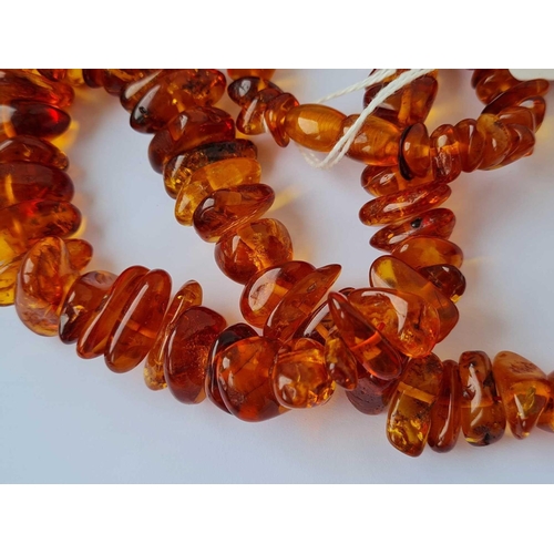 111 - A string of amber beads 24 inch     75 gms