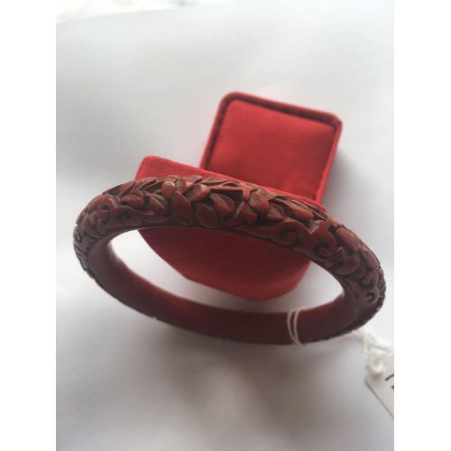 128 - A carved Cinnabar bangle