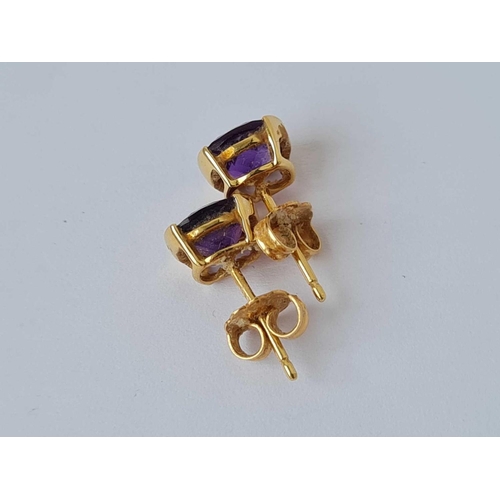 211 - A pair of amethyst earrings 18ct gold   1.6 gms