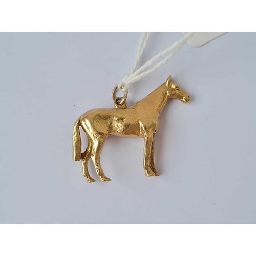 216 - A heavy cast gold horse pendant 9ct   10.1 gms