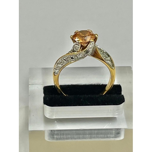 244 - A vintage diamond and orange stone ring