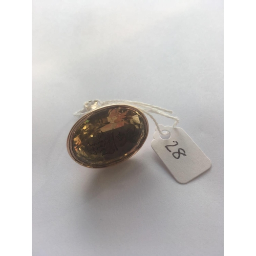 28 - A LARGE GEORGIAN SEAL SET WITH A FACETED CITRINE CARVED WITH AN INTAGLIO OF A SHIP AND ARMOURED HEAD... 