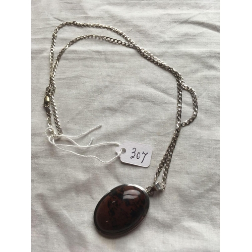 307 - A large matrix hard stone pendant on silver chain