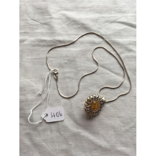 406 - A fancy silver circular amber pendant on a silver neck chain