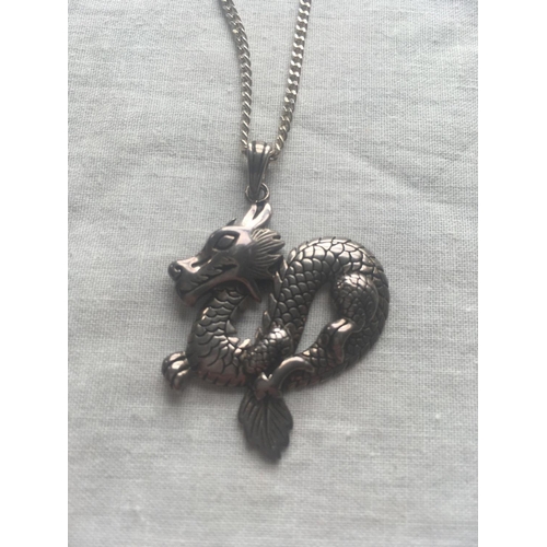 408 - A unusual silver dragon pendant on silver neck chain