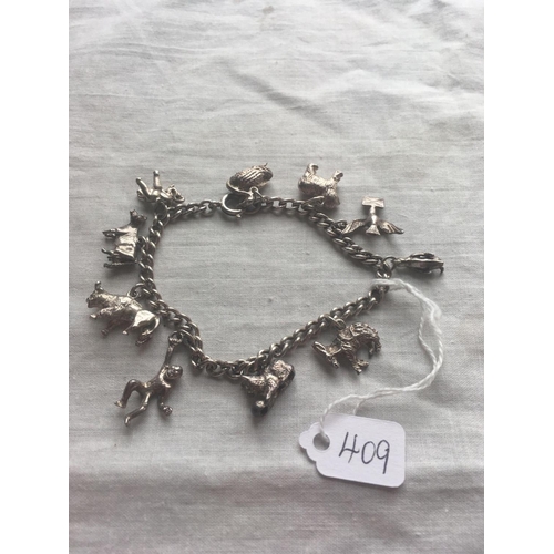 409 - A silver charm bracelet with ten animal charms