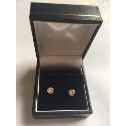 448 - A pair of 18ct white gold and diamond studs