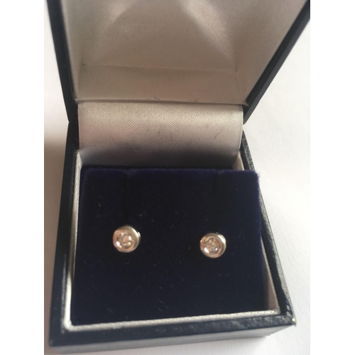 448 - A pair of 18ct white gold and diamond studs