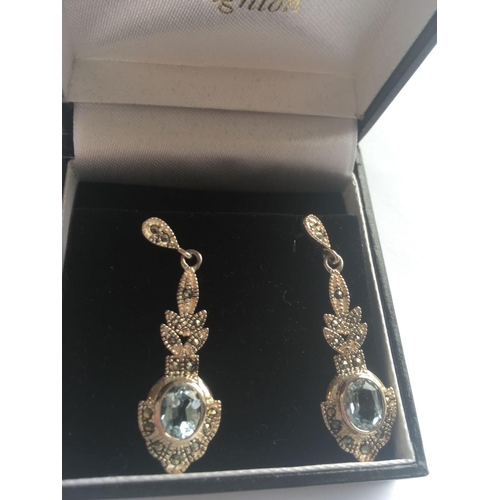 478 - A boxed pair of silver blue topaz pendant earrings