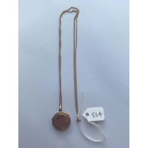 524 - A antique circular back and front locket 9ct on chain