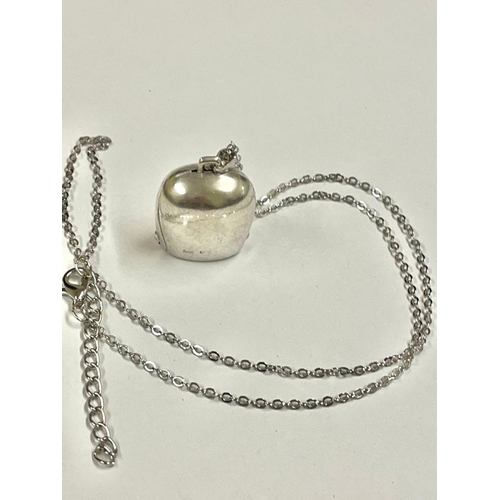 551 - A silver cow bell pendant necklace