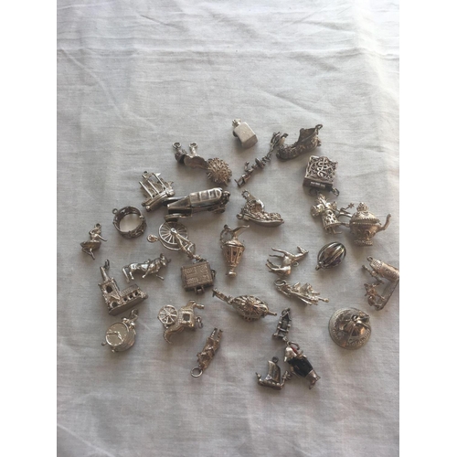 639 - A bag of numerous silver charms    140 gms