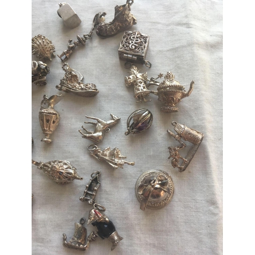 639 - A bag of numerous silver charms    140 gms