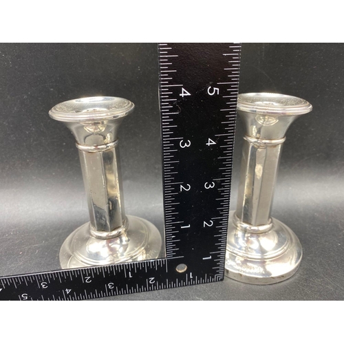 712 - A pair of octagonal stem candlesticks, 4.5