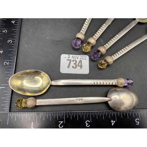 734 - A set of six Chester tea spoons The Thistle shaped finials with purple and orange flower heads, 1911... 