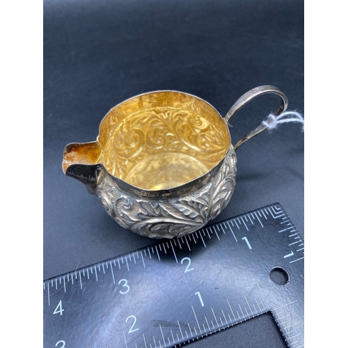 826 - Victorian embossed cream jug with gilt interior. 3.5 inch over handle. Birmingham 1890